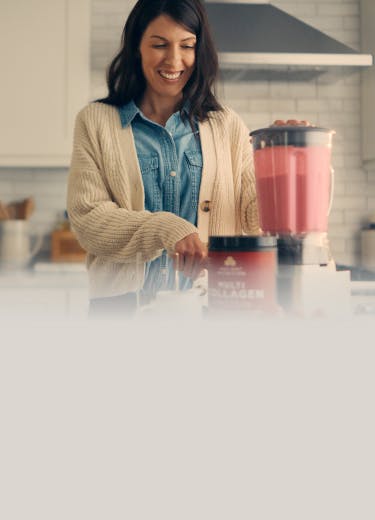a woman making a smoothie with multi collagen protein
