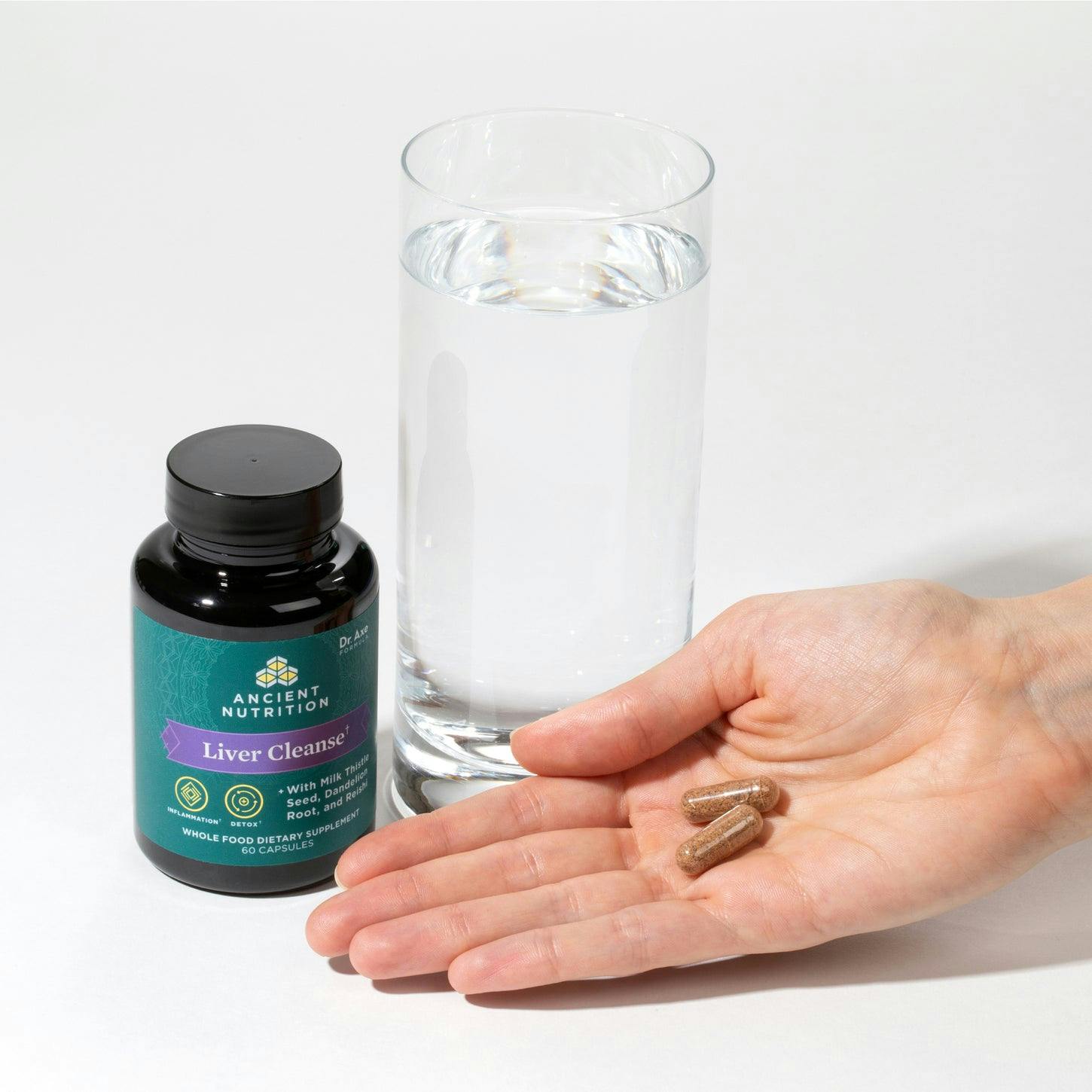 liver cleanse capsule in the palm of persons hand