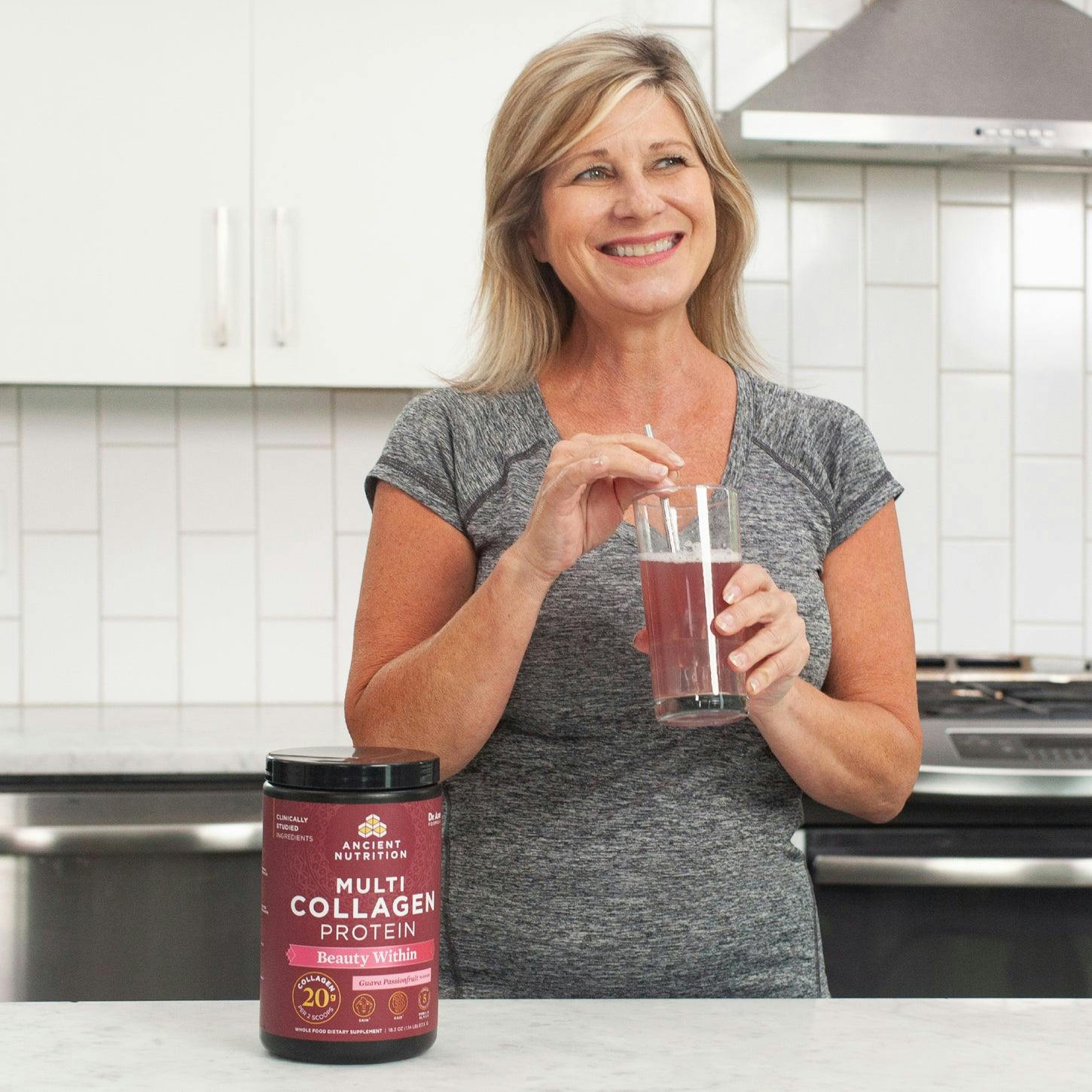 woman drinking a glass of multi collagen protein beauty within 24 servings 