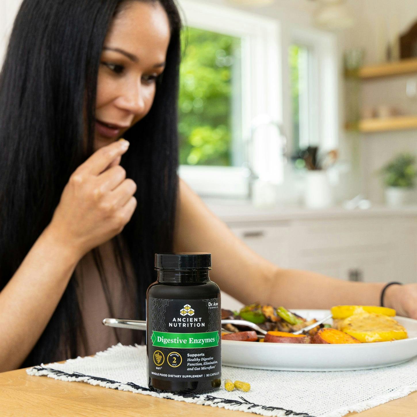 digestive enzymes bottle next to a woman eating