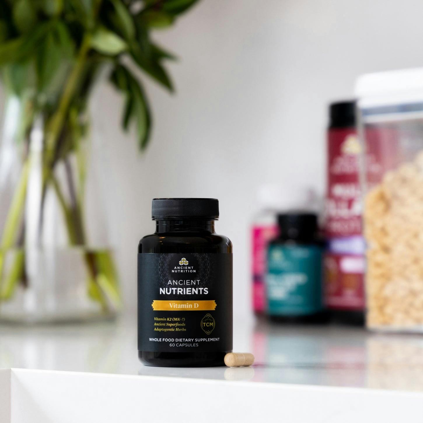 vitamin d on a counter with other supplements in the background
