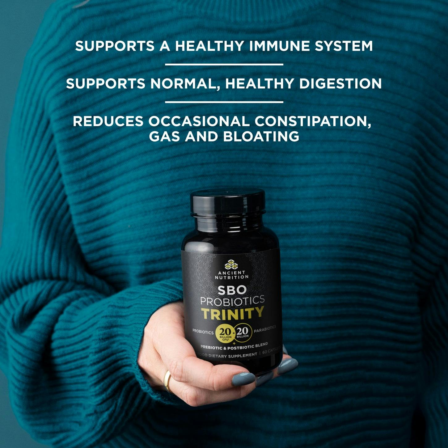 SBO Probiotics Trinity Capsules in a persons hand