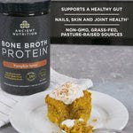 Bone broth protein pumpkin spice bottle next to a spice cake