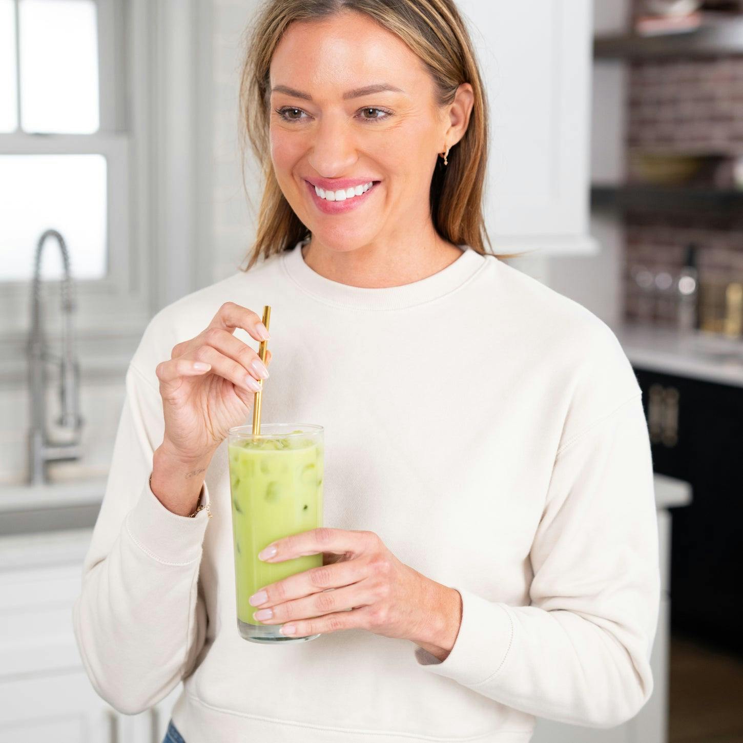 woman drinking iced collagen matcha energizer 