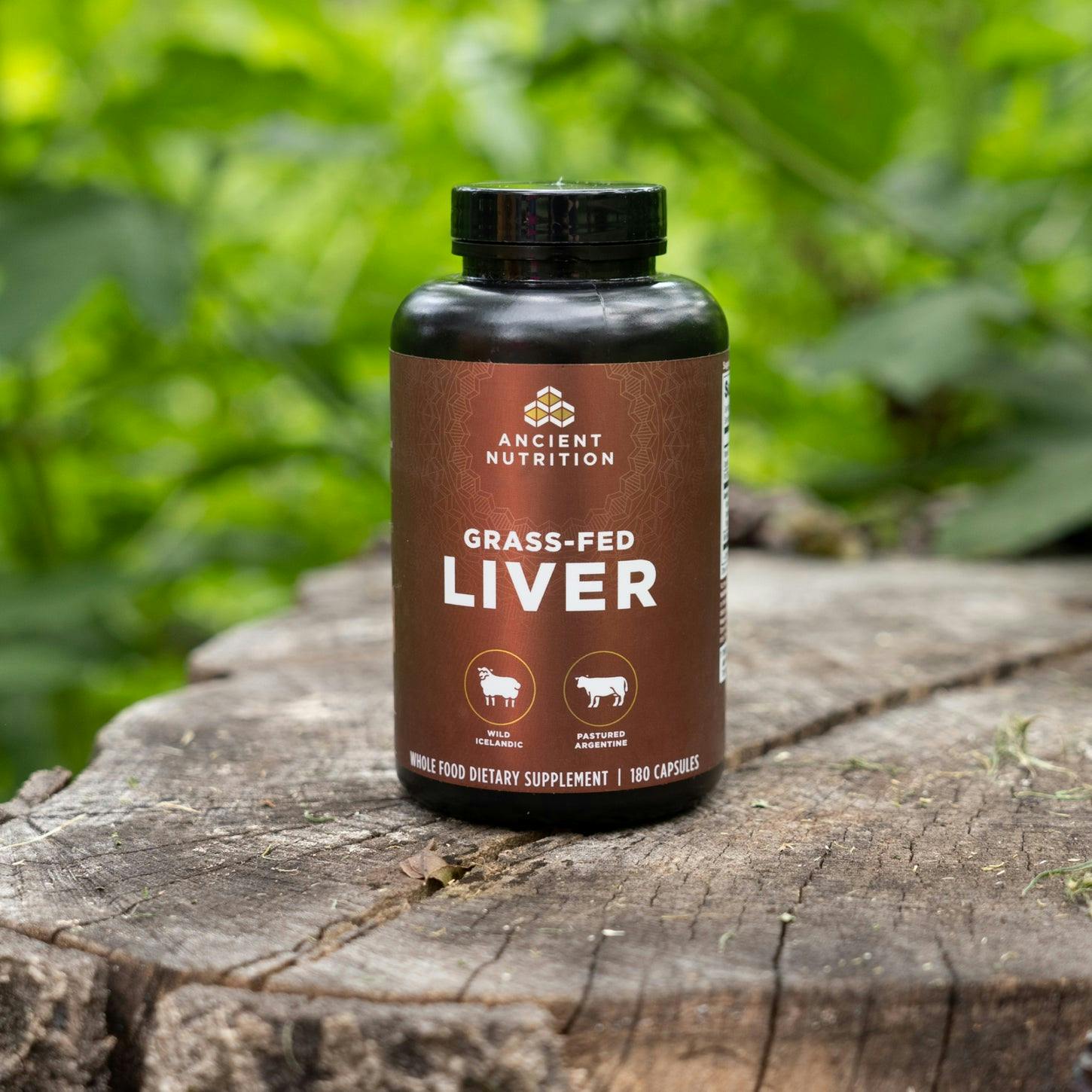 grass-fed liver capsules on a tree stump