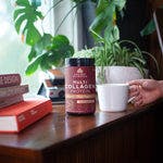 multi collagen protein beauty + sleep support on desk with books and plants