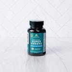 Organic Super Greens + Organic Multi Tablet on a marble background