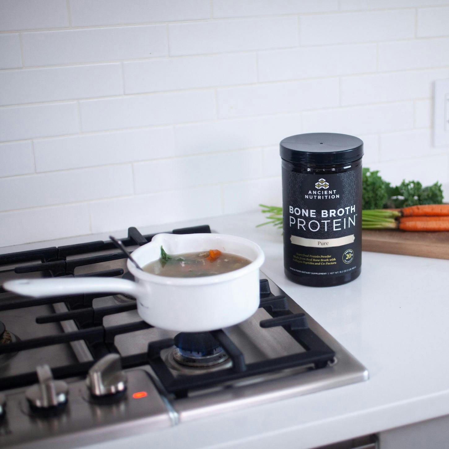 soup on the stove next to a bottle of bone broth protein pure 