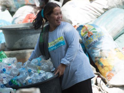 woman picking up plastic