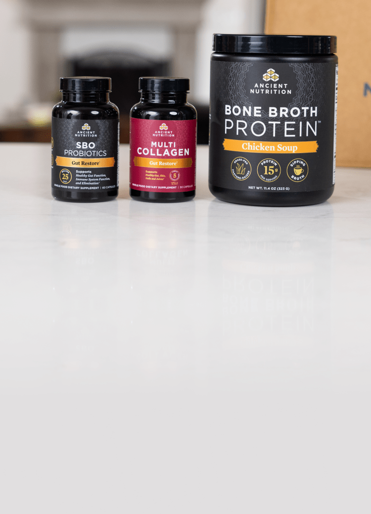 Bottles of Ancient Nutrition Bone Broth Protein, Multi Collagen Capsules, and SBO Probiotics on a white counter