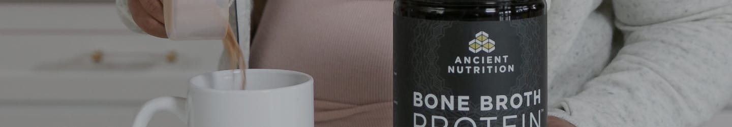 bone broth protein powder next to a white coffee cup