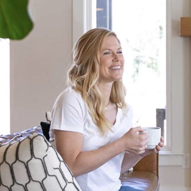 woman holding a white coffee mug