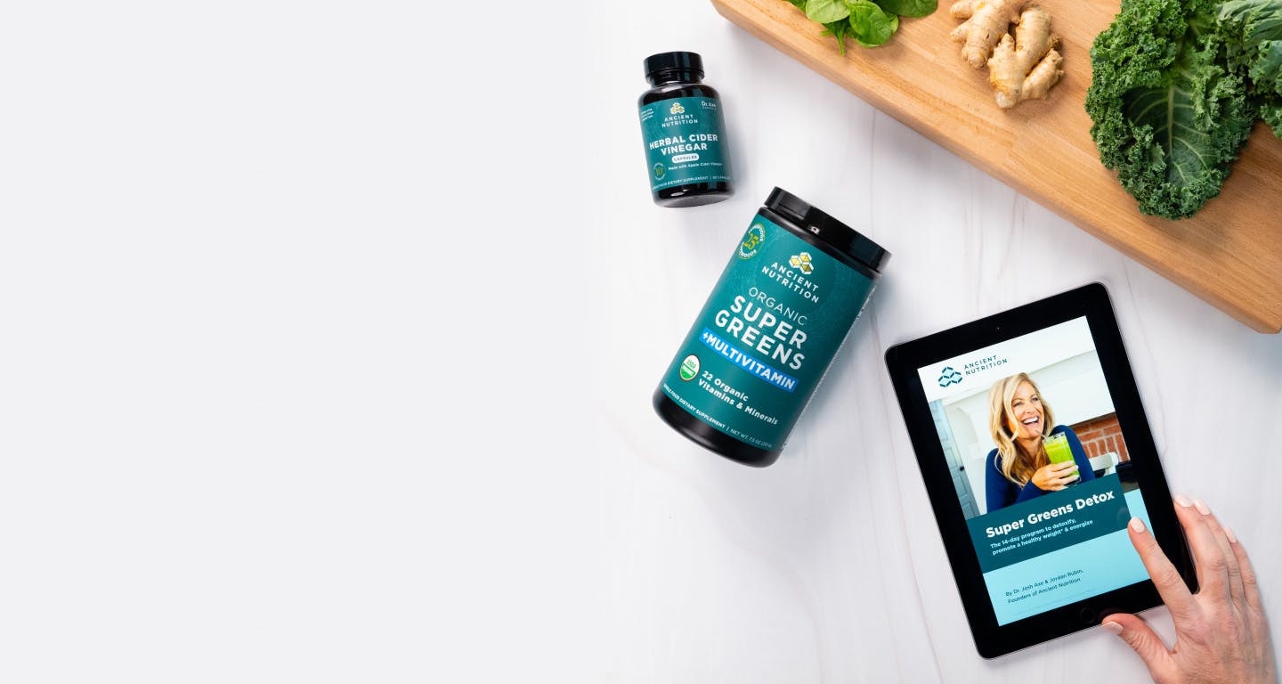 bottle of supergreens next to an ipad