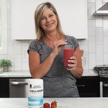 A woman drinking berry smoothie