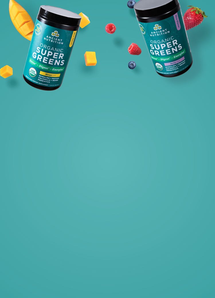 New Ancient Nutrition Organic SuperGreens Mango and Berry Cannisters on a blue background with mangoes and berries
