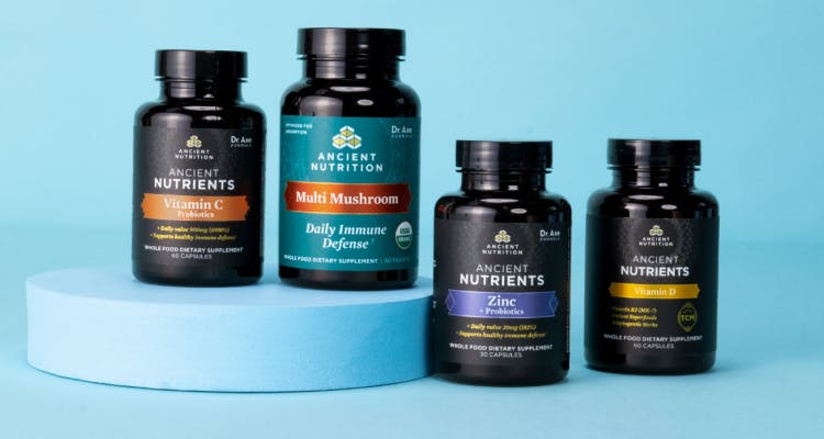 4 bottles of immune support supplements on a black background