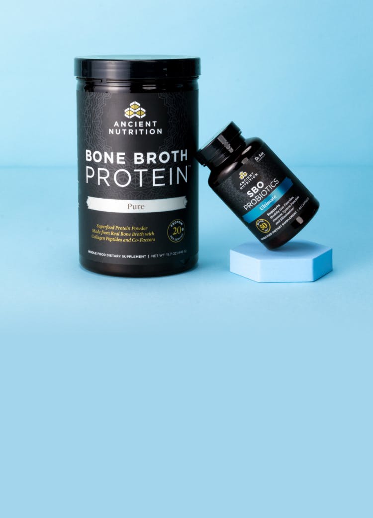bottle of bone broth protein and sbo probiotics on a blue background