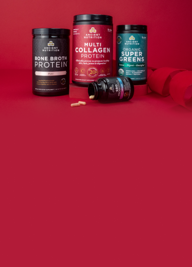 4 bottles of supplements on a ruby red background