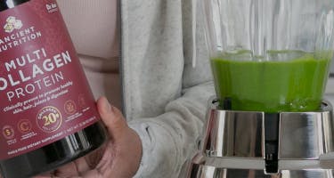 a person scooping multi collagen protein into a smoothie