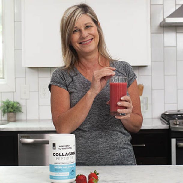 A woman drinking berry smoothie