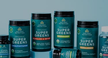 organic supergreens bottles on a light blue background