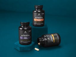 3 bottles of immune support supplements on a dark blue background
