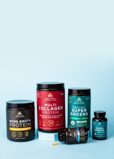 Bottles of Ancient Nutrition bone broth savory, multi collagen protein, organic supergreens powder and tablets, and sbo probiotics on a blue background