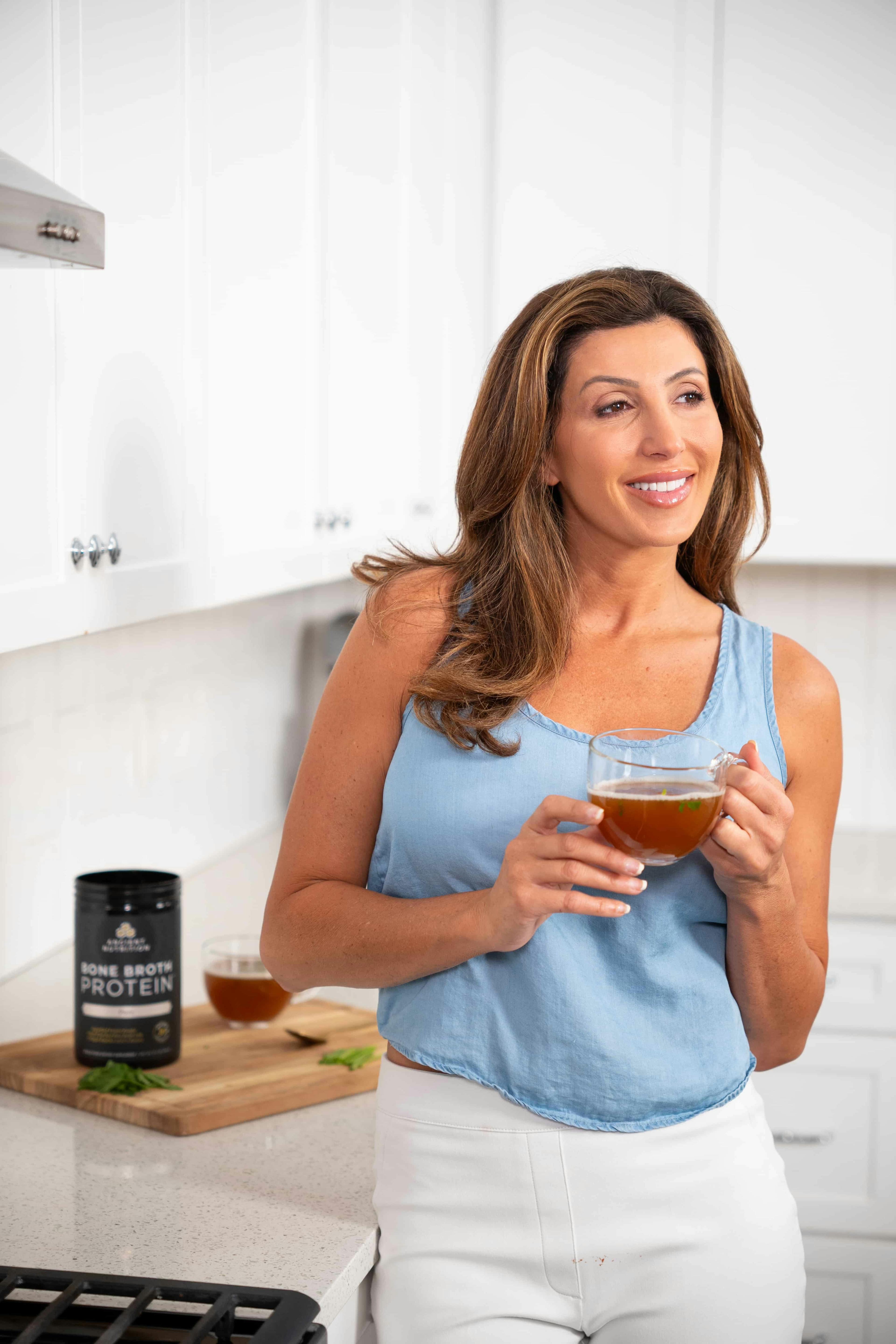 woman in a kitchen with bone broth protein